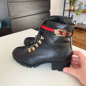Black heeled boots with red and gold accents